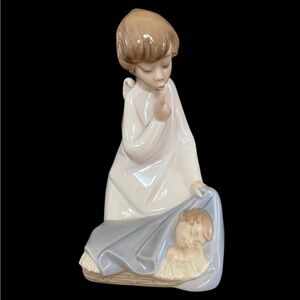 Lladro Guardian Angel watching over sleeping baby